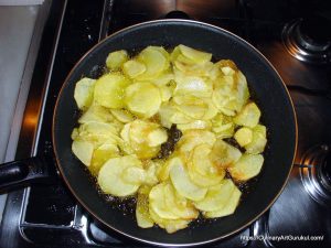 কাটা আলু ভাজার কড়াইয়ে ভাজা হচ্ছে [ Frying Potatoes ]